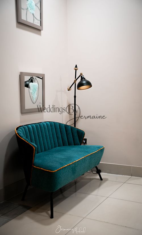 Inside Sketchley Grange Hotel and Spa, featuring a stylish blue sofa and light, captured by Weddings by Jermaine, showcasing the venue’s elegant interior design