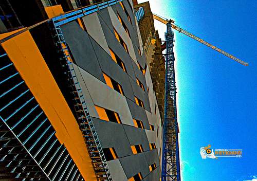 Tower crane elevating above a modern construction site.
