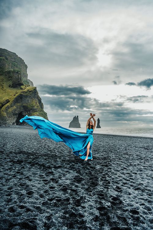 Blue flying dress photoshoot at black sand beach in south Iceland