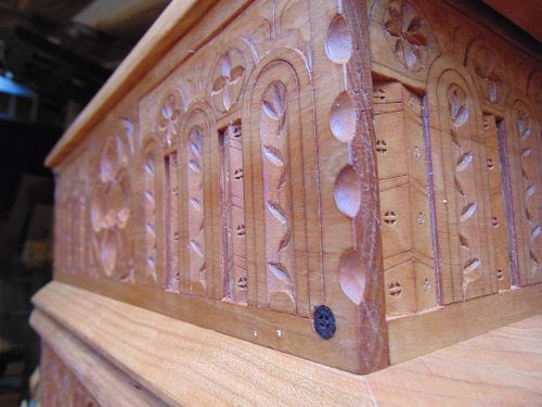 the corner of the carved cherry box with scalloped edges and wooden trunnel pins holding it together.