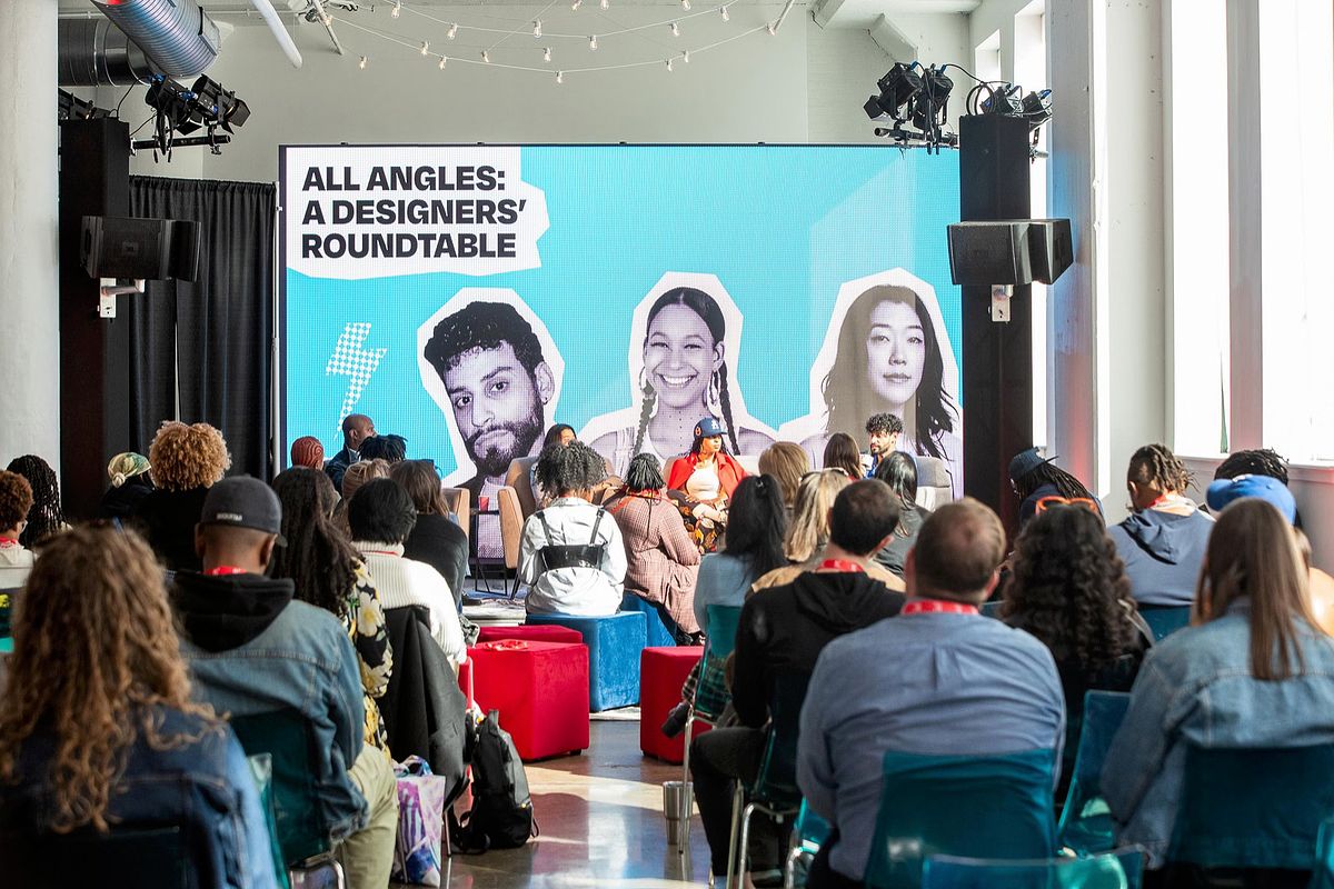 Corporate event photography capturing creative leaders speaking during the “All Angles: A Designers’ Roundtable” session at B.PHL Fest 2023 in Philadelphia, emphasizing innovation, collaborative storytelling, and the exchange of ideas in design.
