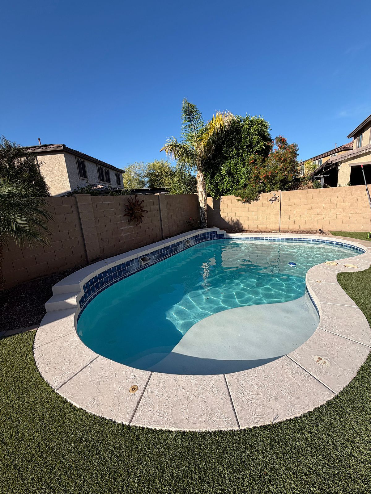 Clean blue pool that was transformed after an acid wash