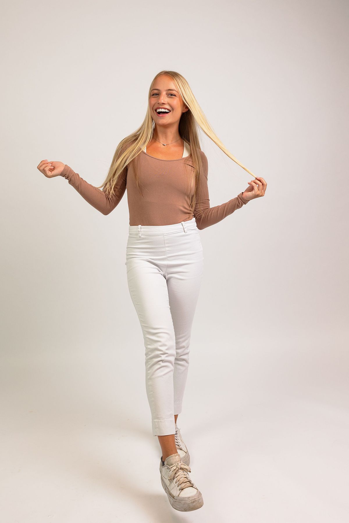 A full-body photograph of a woman against a white backdrop at Innovate Carolina's offices in Chapel Hill, NC