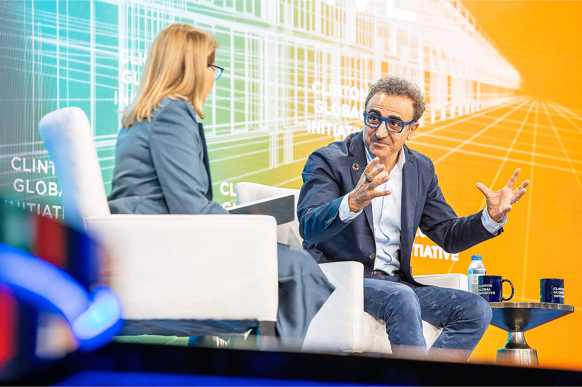 Corporate event photography capturing a business leader in conversation with a journalist during a panel at the Clinton Global Initiative 2024 in New York City, emphasizing leadership, innovation, and social impact.
